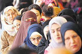 Egyptians queue up at a polling station in Mansura, 120 km north of Cairo, on Saturday.