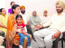 Sukhbinder Singh Gill (right), who escaped the massive earthquake in Tokyo, returned home last weekend. He shares his awful experiences with his wife (left) and child, along with other family members at his residence in Sector 51-A, Chandigarh, on Monday.