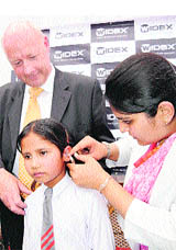 Ambassador of Denmark Freddy Svane with a student of Vatika High School after presenting digital hearing aids in Chandigarh on Monday.
