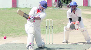 A match of the 59th District Cricket League Tournament in progress at the Survey of India Stadium in Dehradun on Monday.