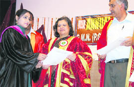 Chief Secretary Urvashi Gulati confers a degree upon a student at GMN College, Ambala Cantt.