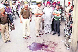 Police officials inspect the crime scene at Madhavpuri in Ludhiana.
