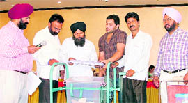 A man takes out a slip during the draw of lots for liquor vends in Ludhiana on Monday.