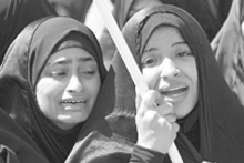 Kin of a person killed during a riot cry during his funeral in Manama.