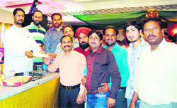 MLA Anil Joshi distributes cheques in Amritsar on Tuesday. 