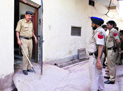 Police personnel inspect the house of Sukhdev Singh, alias Billa, in Burail village, Sector 45, Chandigarh, on Tuesday