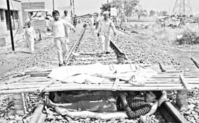 Urchins relax under a makeshift shelter on the rail track at Ramayan village near Hisar.