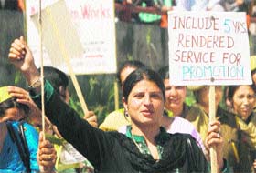 Members of the All Jammu and Kashmir Rehber-e-Taleem Teachers Forum hold a rally in Jammu