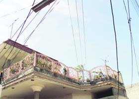 Electricity wires carrying 11 KV current pass over a house in the Sunder Nagar area in Nakodar