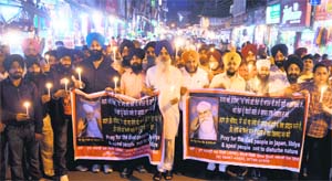 Shopkeepers of Akalgarh Market, Ludhiana, hold a candle-lit vigil to pay homage to those killed in tsunami in Japan and those who have lost their lives in the Libyan uprising, on Tuesday.