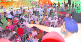 Deputy Chief Minister Sukhbir Singh Badal gives instructions to his political managers and officials with regard to arrangements at the venue of the conference at Khatkar Kalan on Tuesday.
