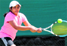 A player plays a shot during a match at the CLTA-AITA Super Series Tennis Tournament