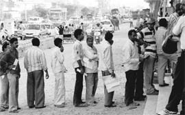 Truck drivers wait in a queue to deposit sales tax at a barrier in Zirakpur