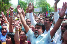 The BJP activists protest against the Delhi governments Budget near the Assembly on Monday.