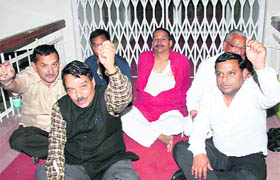 Congress legislators hold a dharna against the eviction of Kishore Upadhyaya (in red kurta) from the well of the state Assembly in Dehradun on Tuesday night.