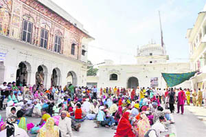 Devotees, who have come from all over for the Jhanda Mela, relax at the Guru Ram Rai Darbar in Dehradun on Wednesday.