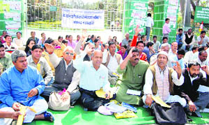 Activists of various organisations stage a dharna at the Gandhi Park in Dehradun on Wednesday.