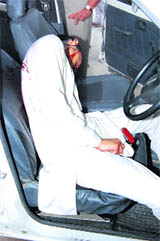 The body of Dera Sacha Sauda follower Vinod inside a car parked outside the court complex at Sirsa on Wednesday.