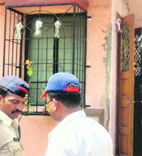 Officials of the Enforcement Directorate outside the house of Sunil Shinde, chartered accountant of Hasan Ali Khan, in Pune on Wednesday.