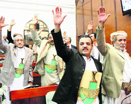 Members of Yemen's Parliament raise their hands as they vote in favour of the state of emergency declared by the country's President Ali Abdullah Saleh in Sanaa on Wednesday.