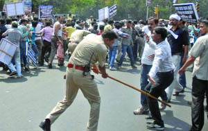 Police lathicharges activists of the Readymade Garments and North Dealers Welfare Association (Regd) during a protest against excise duty imposition on readymade garments, at Pusa Road in New Delhi on Thursday.