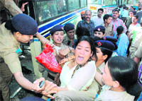 Family members of deceased Uttarakhand Transport Corporation employees stage a dharna in Dehradun on Thursday. 