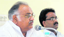 Haryana Vidhan Sabha Speaker Kuldeep Sharma addresses a meeting of district officers at Sonepat as DC Pankaj Aggarwal (right) looks on.