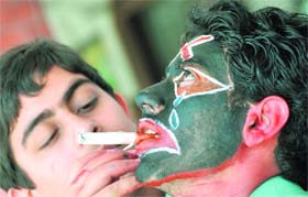 KILLER PUFF: On World TB Day, a schoolboy expresses his concern on the outcome of smoking through face painting in Ludhiana