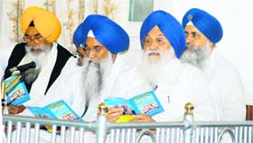 SGPC president Avtar Singh Makkar and Sikh high priests reading a copy of the budget speech at Teja Singh Samundari Hall in Amritsar