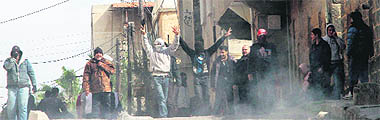 Anti-government activists gesture as they gather on the streets of Daraa, on Wednesday. 