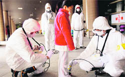 An evacuee is screened at a shelter for leaked radiation from the damaged Fukushima nuclear plant on Thursday.