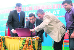 Justice Altamash Kabir (centre) of the Supreme Court inaugurates a website of the state Legal Services Authority as Nainital High Court Chief Justice Barin Ghosh (left) looks on at a function in Dehradun on Friday
