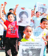 Members of the All Ladakh Muslim Students Association protest outside the UN Observers office in Jammu on Friday, against the air attack by foreign forces on Libya.