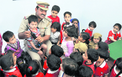 SHO Paramjit Singh familiarises children with a wireless set during an educational tour to the Sadar police station in Ludhiana 