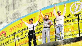 Agitating jobless teachers atop a water tank at Race Course in Dehradun