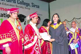 Union Minister Ajay Maken gives away a degree to a student of the CMK PG College for Women in Sirsa