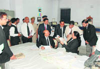 Justice MM Kumar (standing second from right) of the Punjab and Haryana High Court hears a dispute during a mega lok adalat at the District Courts Complex in Ludhiana on Saturday.