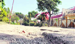 A picture of a damaged road at Vivek Vihar, Ward No. 3, in Dehradun.