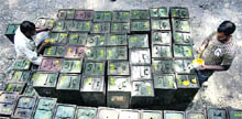 Readying for the poll cast: Workers mark ballot boxes for the upcoming panchayat election at Bari Brahmana in Jammu on Sunday. 