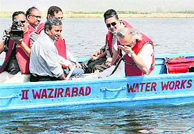 Environment Minister Jairam Ramesh smells Yamuna water in New Delhi on Sunday.
