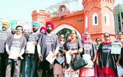 Members of the Khalsa College Teachers Union, Amritsar, protest at Hall Gate in Amritsar on Sunday