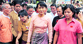 Myanmar's democracy icon Aung San Suu Kyi (centre) arrives at her National League for Democracy party's headquarters to attend the 66th anniversary of Anti-Fascist Resistance Day in Yangon on Sunday.
