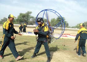 Paramotor adventurists check details while getting ready for take off at Sadhuwali near Sriganganagar