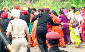 Policemen lathi charge agitating women pharmacists outside the PCA Stadium in Mohali on Monday.
