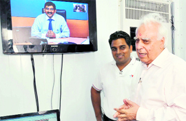 Union Minister for Communication and Information Technology Kapil Sibal at an e-learning centre at Badshahpur village in Gurgaon district on Monday.