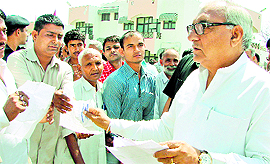 Chief Minister Bhupinder Singh Hooda hears grievances of residents in Rohtak on Monday.