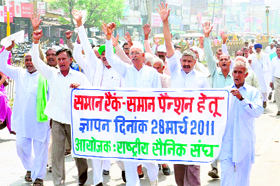 Ex-servicemen hold a protest under the banner of the Bharatiya Sainik Sangh demanding one rank, one pension, in Karnal on Monday.