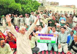 Members of the Tehreek-e-Insaf protest at the Mubarak Mandi complex in Jammu on Monday.