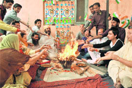 Cricket fans perform a yajna in Jammu on Monday for the victory of the Indian cricket team in the World Cup semifinal.