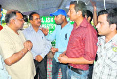 Avinash Rai Khanna interacts with the protesting employees of the Forest Department at Mubarak Mandi in Jammu on Monday.